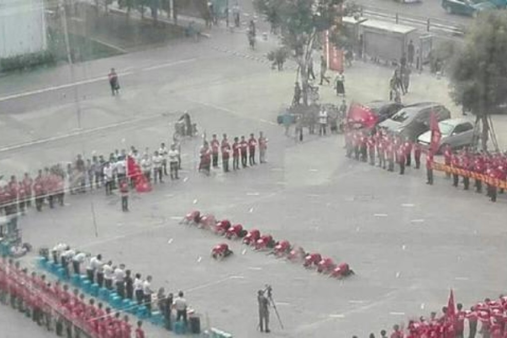 Restaurant staff kneel in a public square in Shenyang city in northeastern Liaoning province. Photo: SCMP Pictures