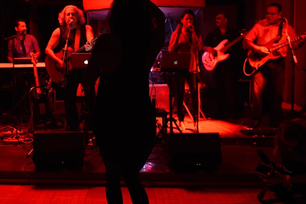 A band plays at "Hard Rock Cafe", a nightclub that opens twice a month in a private home.