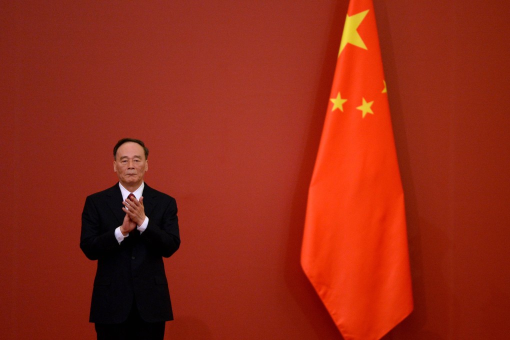 Wang Qishan applauds as he attends an awards ceremony marking the 70th anniversary of the end of World War II in Beijing on September 2. Photo: AFP