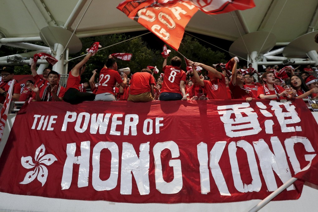 A Hong Kong fan waves a flag at the World Cup qualifying match against Qatar in Hong Kong. Photo: Reuters