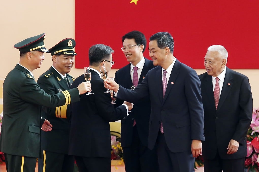 Director of the Central Government's Liaison Office in Hong Kong Zhang Xiaoming, third from right, and Hong Kong Chief Executive Leung Chun-ying, second from right, celebrate the 18th anniversary of HKSAR Establishment Day on July 1. Photo: Jonathan Wong