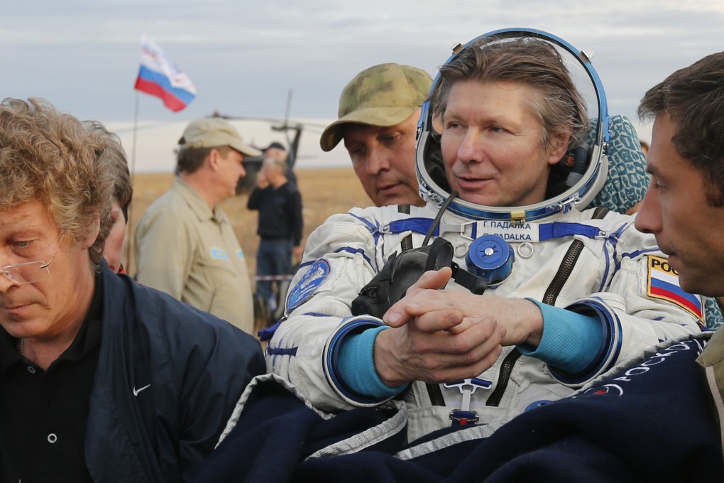 Russian cosmonaut Gennady Padalka is carried away after landing in Kazakhstan. Photo: AFP