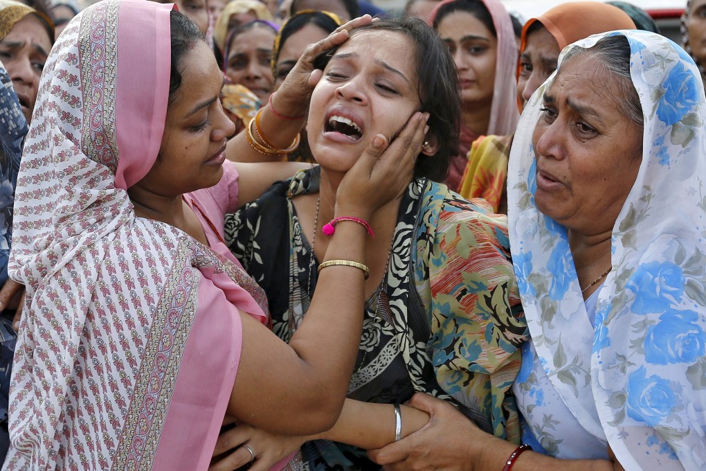 A woman is consoled during the funeral of her father who died in the bast in central Madhya Pradesh state. Photo: Reuters