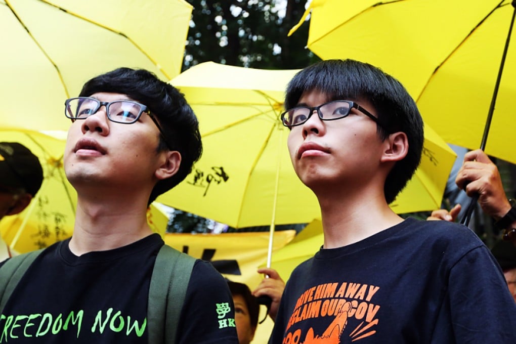 Nathan Law (left) and Joshua Wong (centre) are among the Occupy Central leaders scheduled to take part in this month's one-year anniversary seminar at Tamar Park. Photo: Sam Tsang