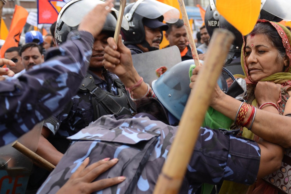 Nepalese police stop Hindu activists as they try to break through a cordoned-off area near parliament during a protest demanding Nepal be declared a Hindu state in Kathmandu. Photo: AFP