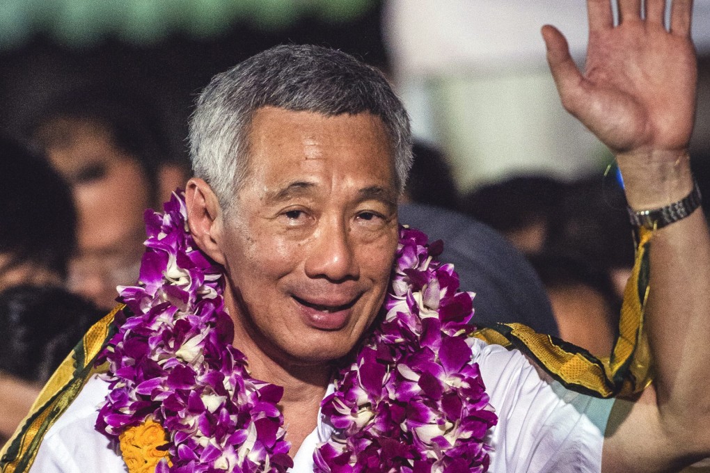 Singapore Prime Minister and secretary general of the ruling People's Action Party Lee Hsien Loong celebrates at the Toa Payoh stadium where supporters have gathered to hear the announcements of the results in the Singapore General election. Photo: EPA