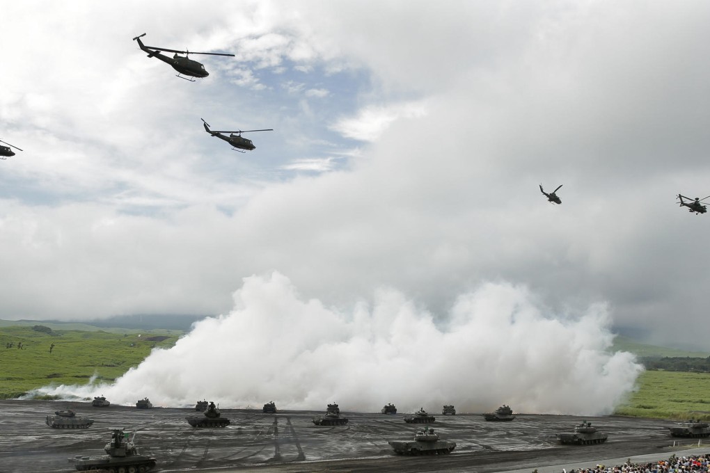 Japanese helicopters and tanks during a live fire exercise last month. Photo: Bloomberg
