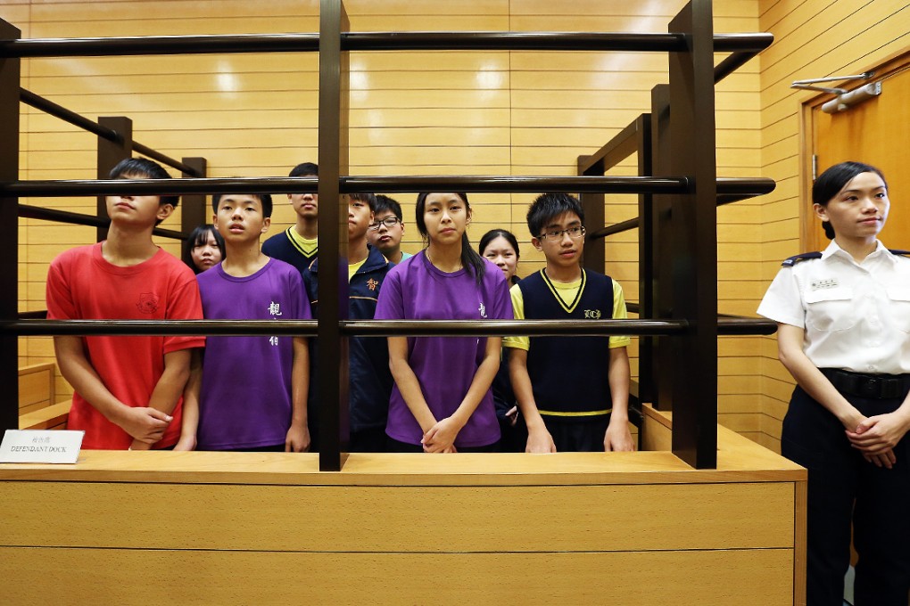 An officer 'stands guard' as school pupils get their first experience of life in prison at Ma Hang in Stanley. Photos: K.Y. Cheng