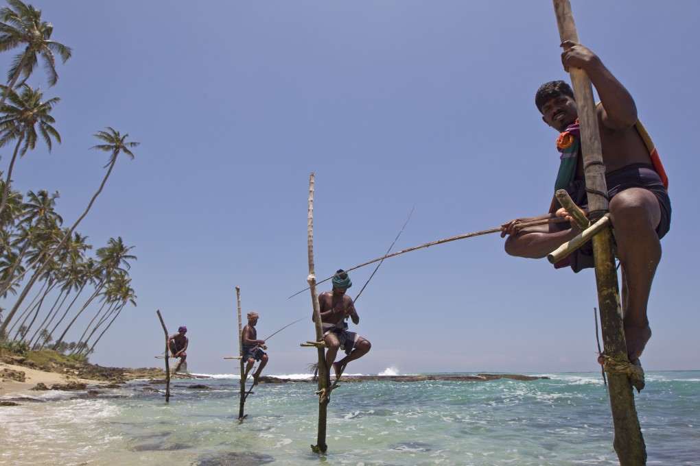 Stilt fishermen along the Galle coastline. Photo: Corbis