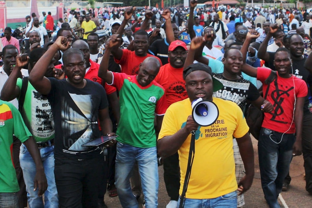 Protesters demonstrate against the presidential guard in Ouagadougou, Burkina Faso. Soldiers fired warning shots outside Burkina Faso's presidential palace on Wednesday as hundreds of people gathered to protest the detention of government leaders inside by the elite presidential guard, witnesses said. Photo: Reuters