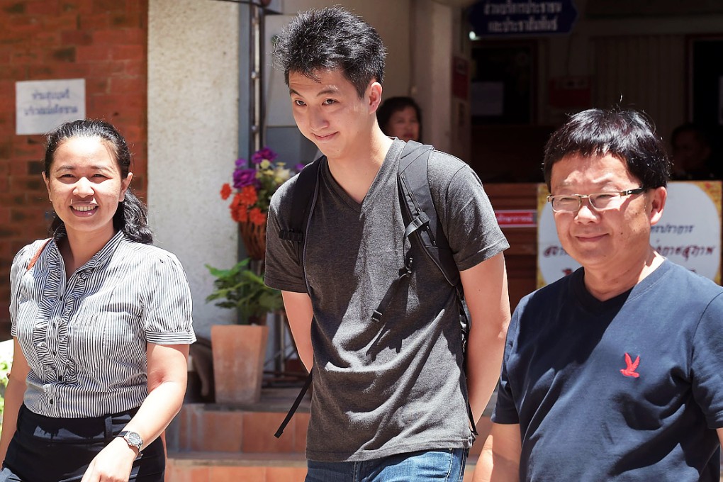 Hong Kong photojournalist Anthony Kwan Hok-chun walks with lawyers as they arrive at an earlier court hearing in Thailand. Photo: AFP