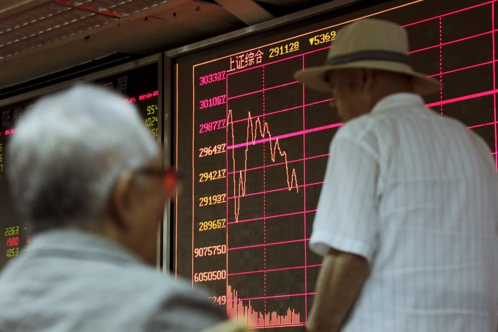 An investor strolls by an electronic board showing stock information of the Shanghai Stock Exchange Composite Index. Photo: Reuters