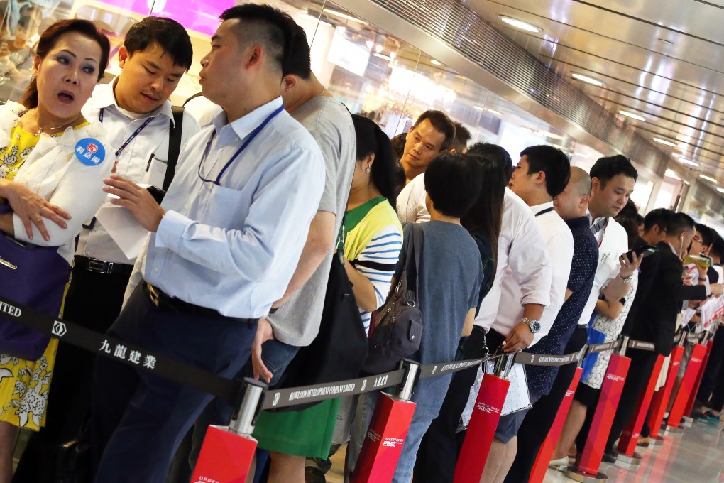 Prospective buyers for Kowloon Development's Upper East project line up at the sales office on Thursday. Photo: K.Y. Cheng