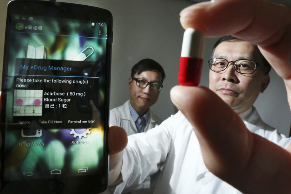 Pharmacists Johnny Wong Sze-ho (left) and William Chui Chun-ming show the app eDrug. Photo: Nora Tam