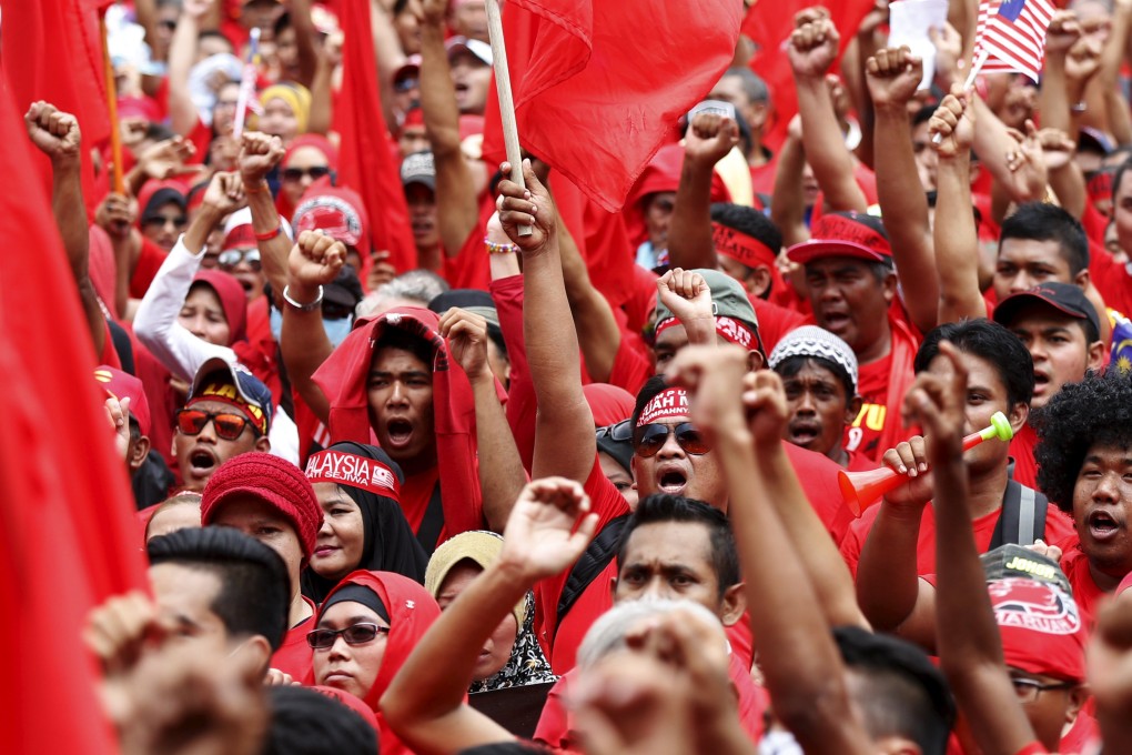 "Red shirt" demonstrators in Kuala Lumpur gather in a rally last week, to counter a massive protest last month calling for the prime minister to resign. Photo: Reuters