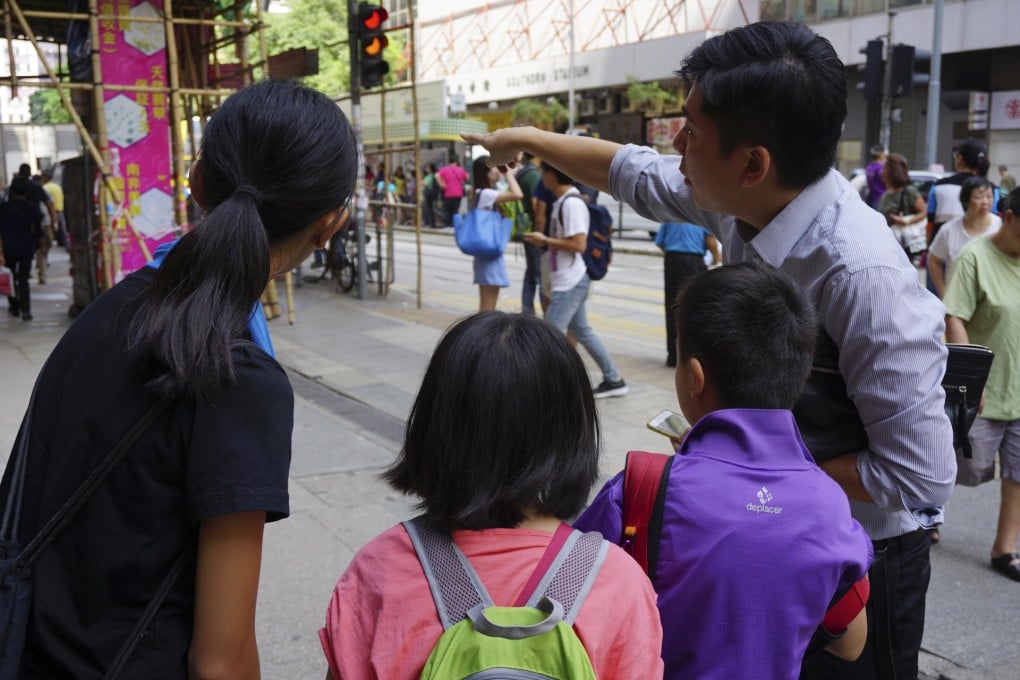 Gap year students ask a passer-by for directions.