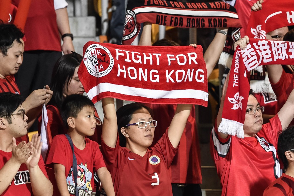 Hong Kong fans hold up banners during the Qatar match. Photo: AFP
