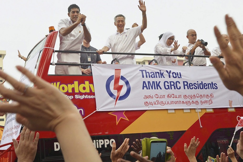 Singapore prime minister Lee Hsien Loong  waving during a victory parade after his People's Action Party was re-elected. Photo: EPA