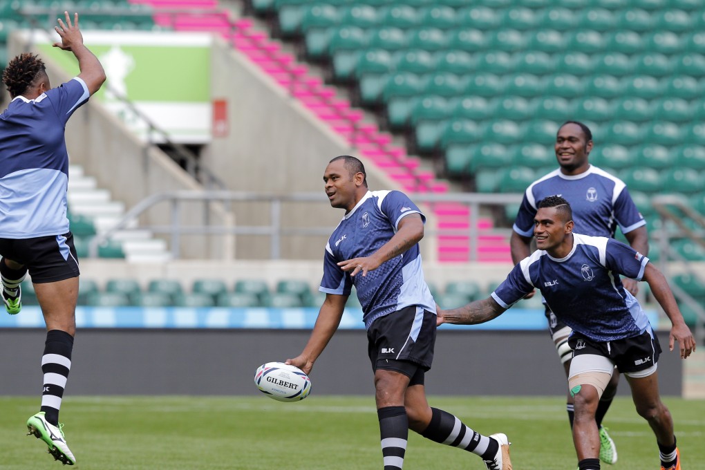 Fiji captain Akapusi Qera (centre) passes the ball in training at Twickenham Stadium. Photo: AP