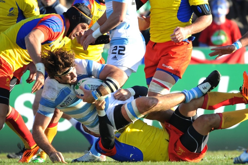 Lifting weights, stretching and press-ups have helped Ovidiu Toniţa (left) make it into Romania’s Rugby World Cup squad for a fifth time. Photo: AFP
