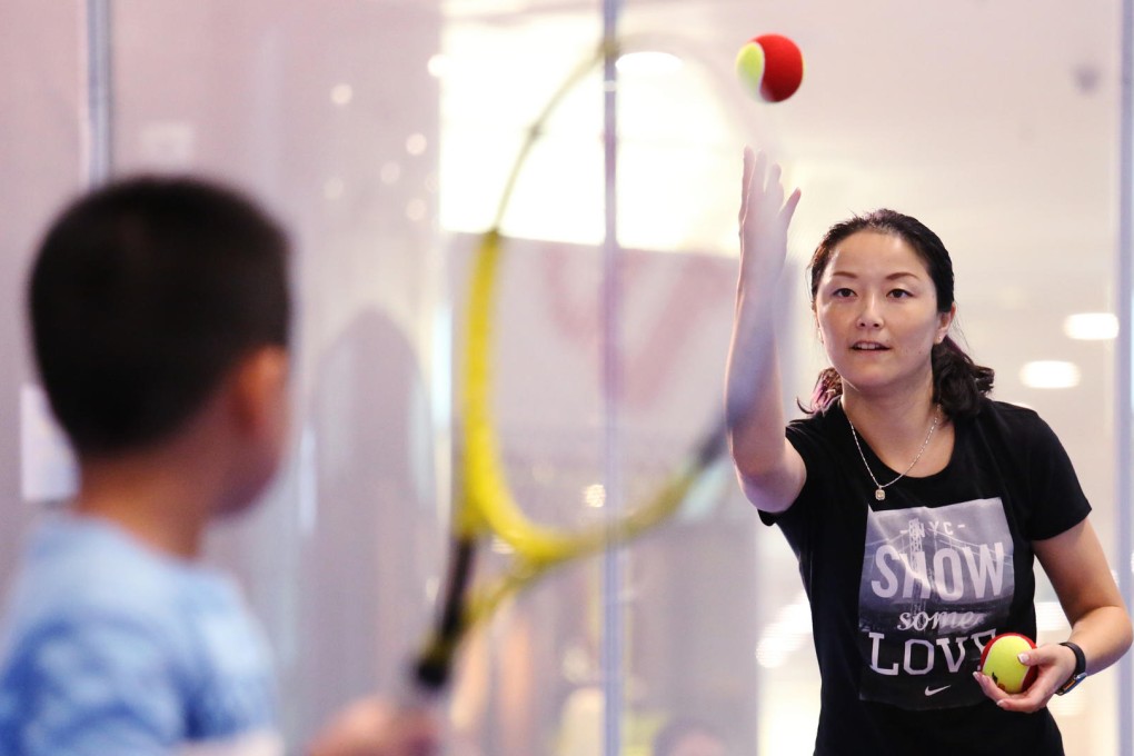 Retired Chinese player Yan Zi instructs a young player during a promotional event. Photo: Nora Tam