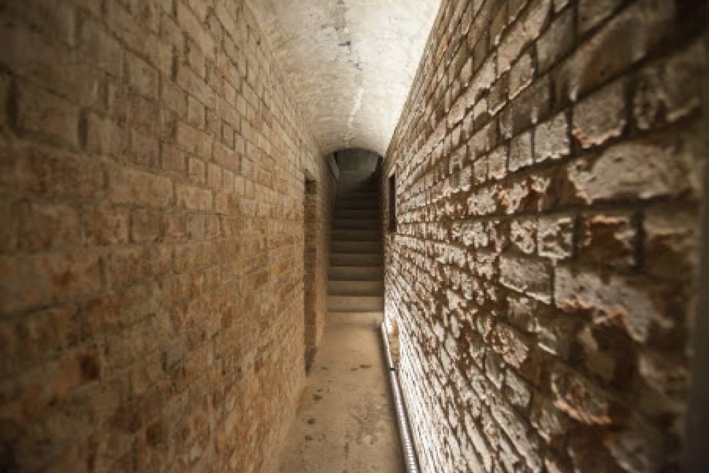 An old brick tunnel where prisoners used to be led into court from their cells is seen in Hong Kong's new Court of Final Appeal Building. Photo: EPA
