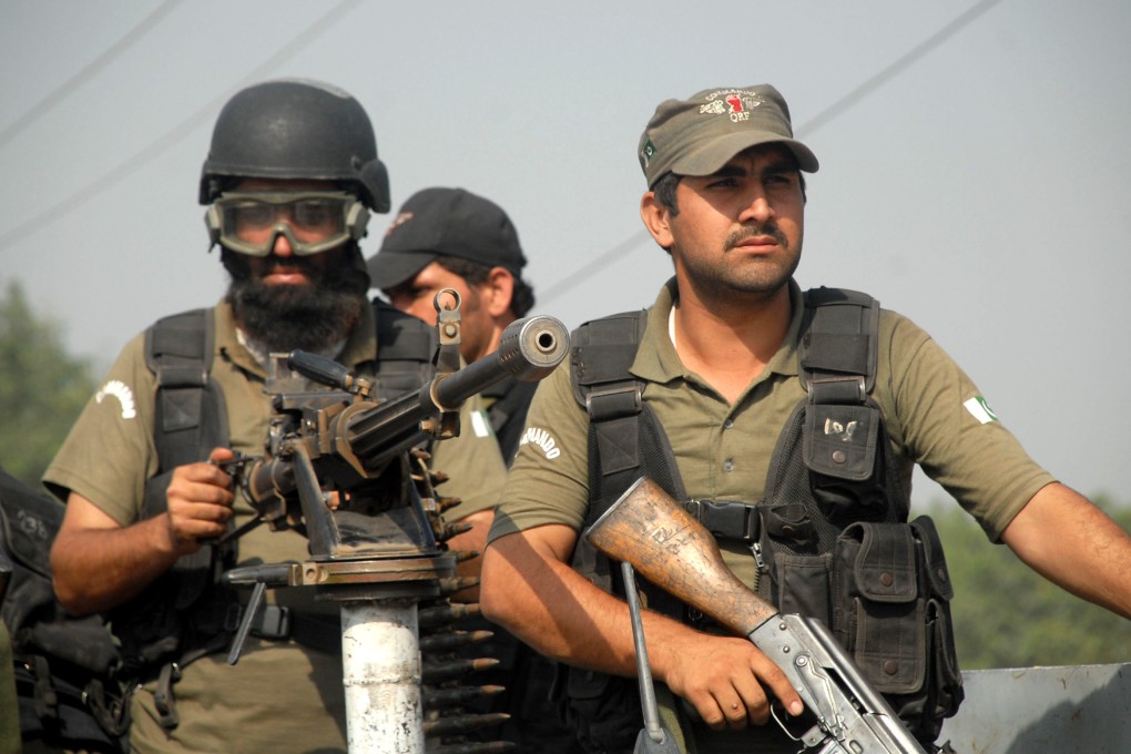 Pakistani security personnel take position outside a Pakistan Air Force base after the attack. Photo: Xinhua