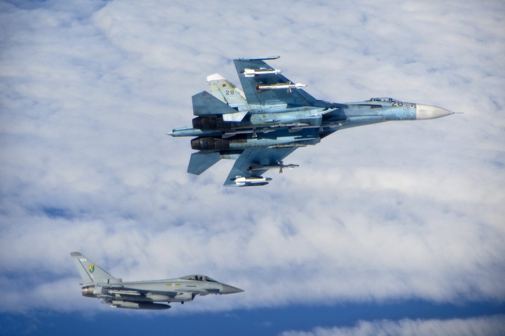 A British Royal Air Force Typhoon fighter (bottom left) shadows a Russian Sukhoi Su-27 ‘Flanker’ fighter in Baltic air space in 2014. Photo: EPA