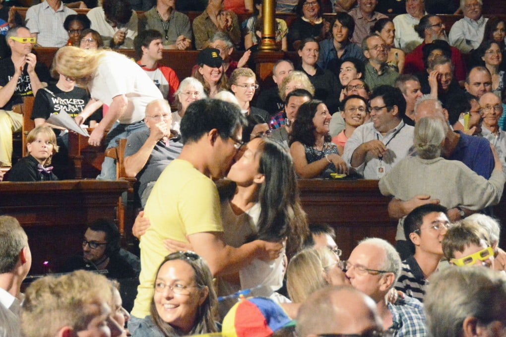 A couple kiss during the spoof Ig Nobel medicine prize ceremony at Harvard University. Japanese scientist Hajime Kimata received the prize jointly with three Slovakian scientists for a study that revealed kissing could reduce allergic reactions in humans. Photo: Kyodo