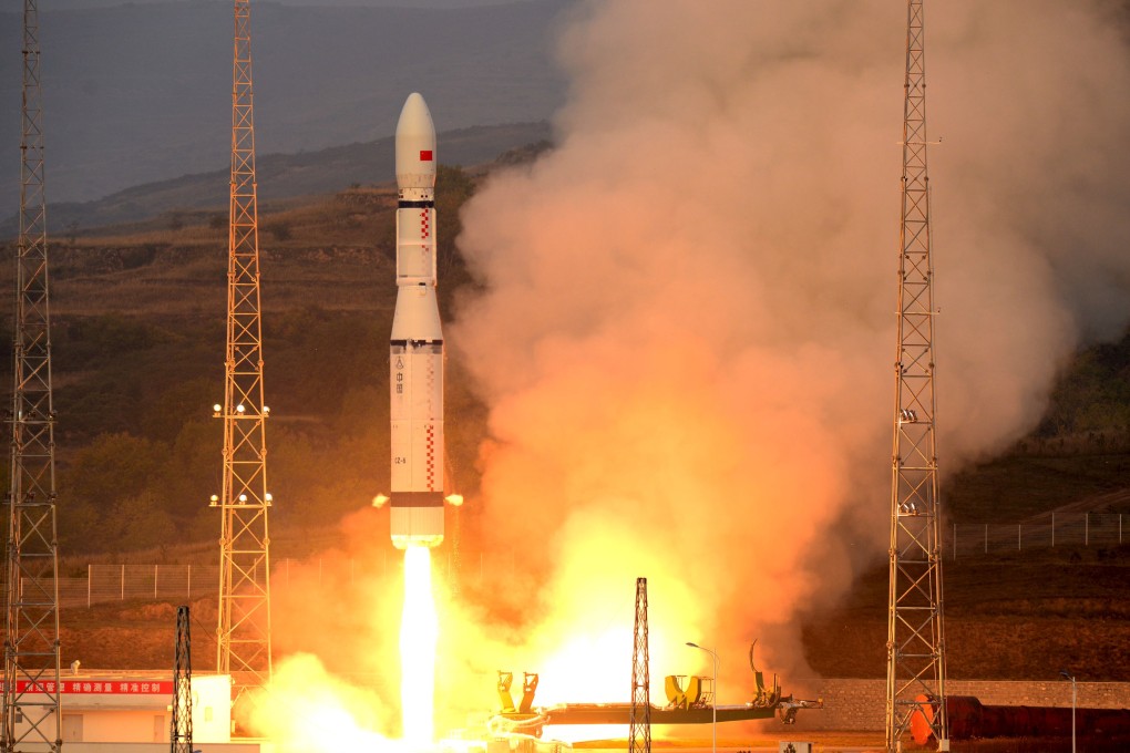 China's Long March 6 rocket, carrying 20 micro-satellites, blasts off from the launch pad in Taiyuan, Shanxi province, on Sunday. Photo: Reuters