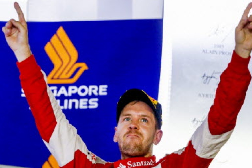 Ferrari driver Sebastian Vettel celebrates winning the Singapore Grand Prix. Photo: EPA