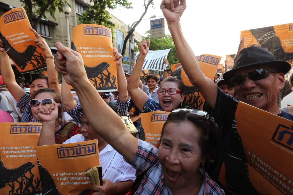 Thai anti-coup activists shout slogans during a rally organised by the New Democracy Movement. Photo: EPA