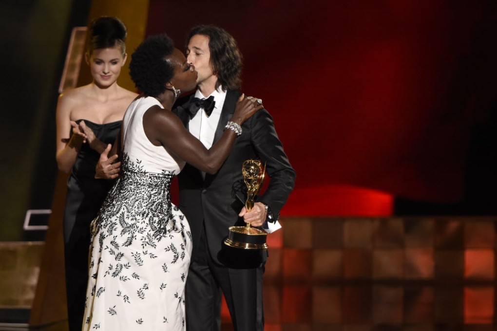 Viola Davis kisses presenter Adrien Brody  as she accepts the award for outstanding lead actress in a drama series for “How to Get Away With Murder” at the 67th Primetime Emmy Awards at the Microsoft Theatre in Los Angeles. Photo: AP