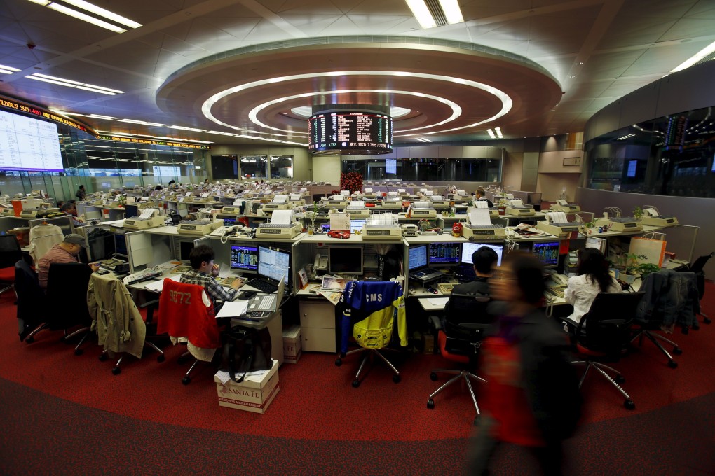 Floor traders monitor share prices during morning trading at the Hong Kong Stock Exchange. Photo: Reuters
