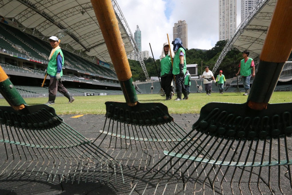 Ground staff work on the pitch at the Hong Kong Stadium. Photo: Felix Wong
