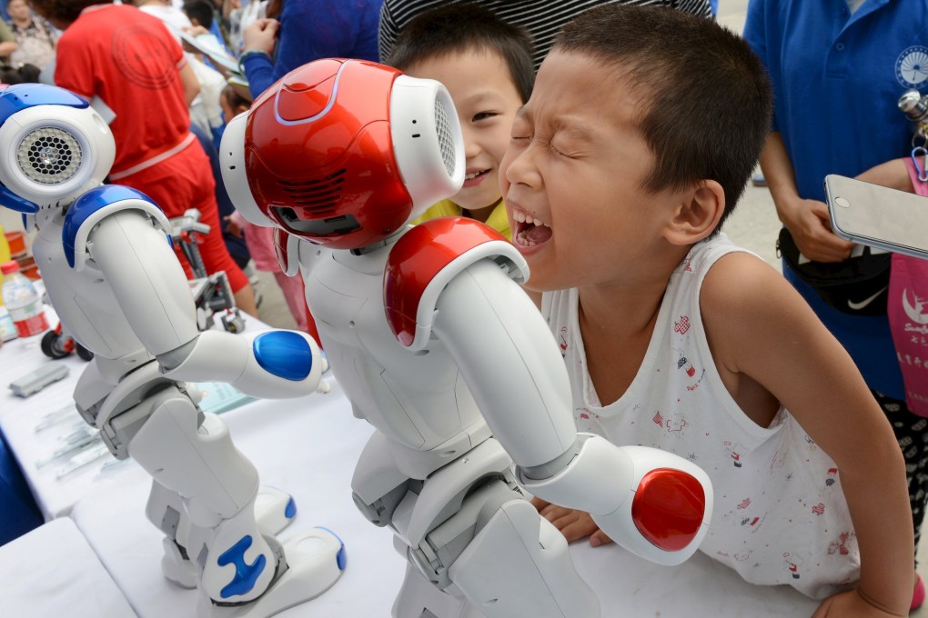 A boy tries to talk to a humanoid robot during a science promotional event in Zhengzhou, Henan province in China. Companies are increasingly conscious of having some influence in the way information about their activities is viewed by the public. Photo: Reuters