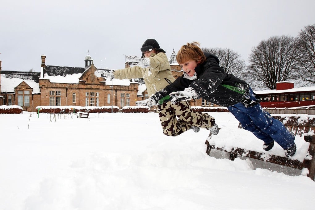 Children in the Scottish town of Linlithgow play in the snow - or 'sneesl'. Photo: AFP