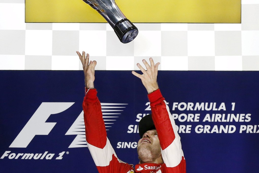 Ferrari driver Sebastian Vettel celebrates on the podium after winning the Singapore F1 Grand Prix at the Marina Bay street circuit. Photo: Reuters