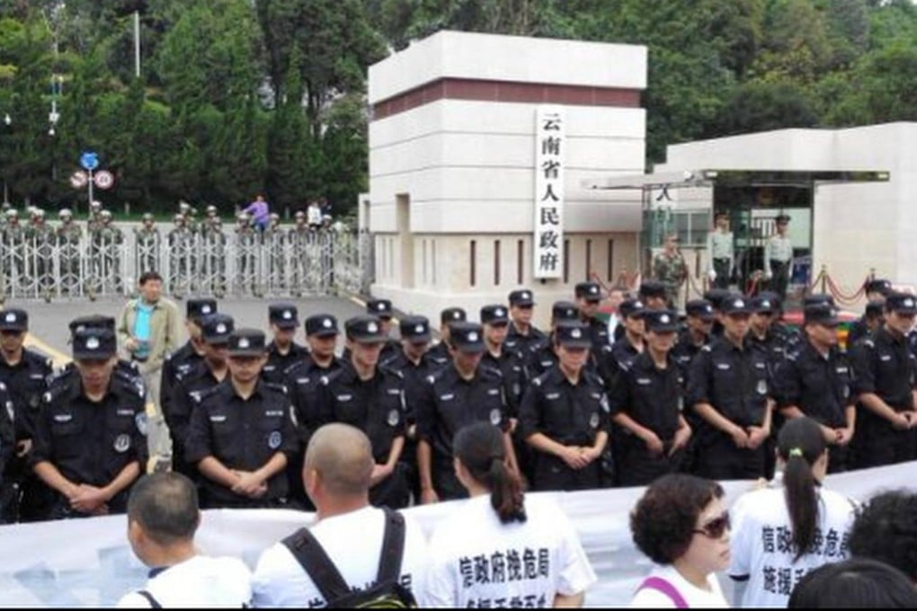 Protesters caught up in the Fanya metals case line up against police in Yunnan. Photo: SCMP Pictures