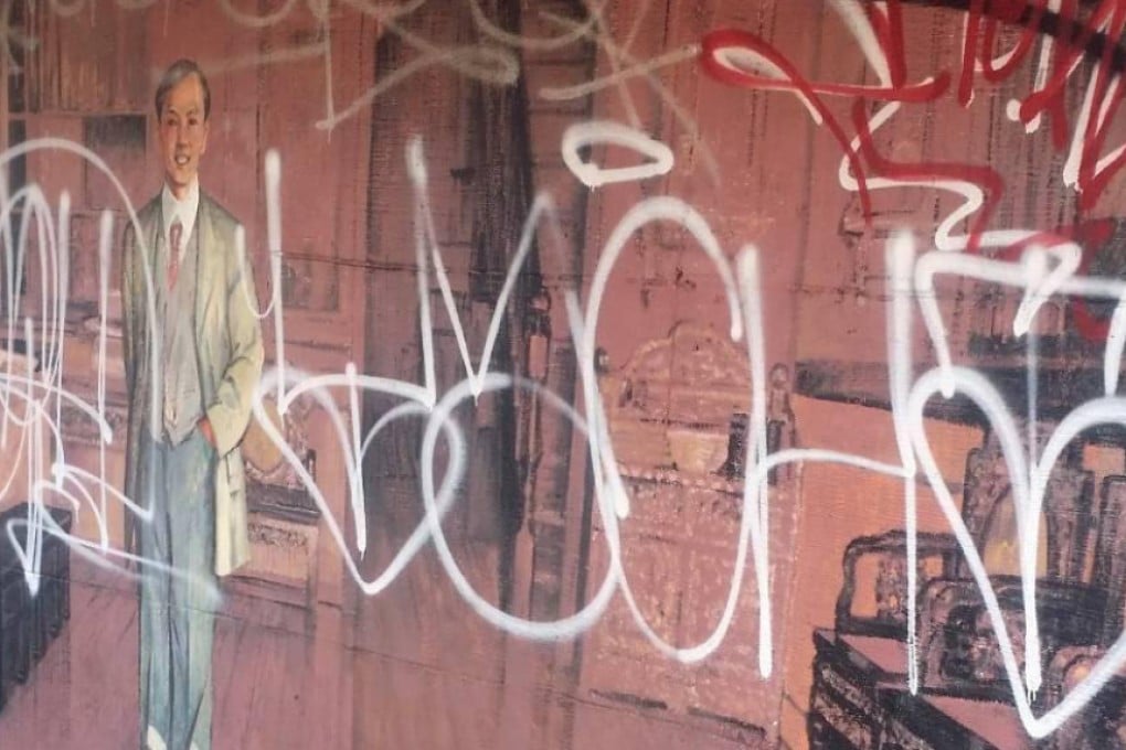 Graffiti on the mural1905: Man in a Suit, in Chinatown, Vancouver.