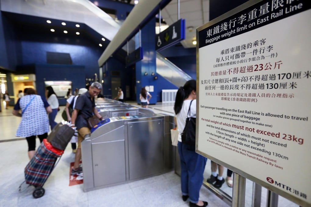 Passengers bring oversized luggage through the gates