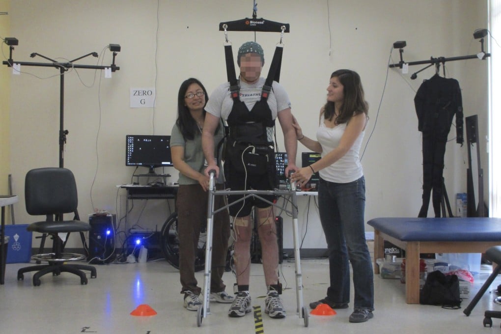 Former graduate student Adam Fritz, 28, who severed his spinal cord in a motorcycle accident, is shown during a brain-computer interface experiment at UC Irvine's iMove Lab in Irvine, California