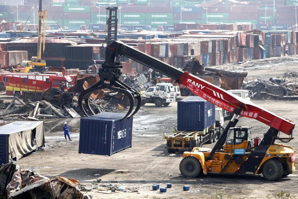 A crane moves away a destroyed container at the core area of an warehouse explosion in Tianjin, north China. Photo: Xinhua
