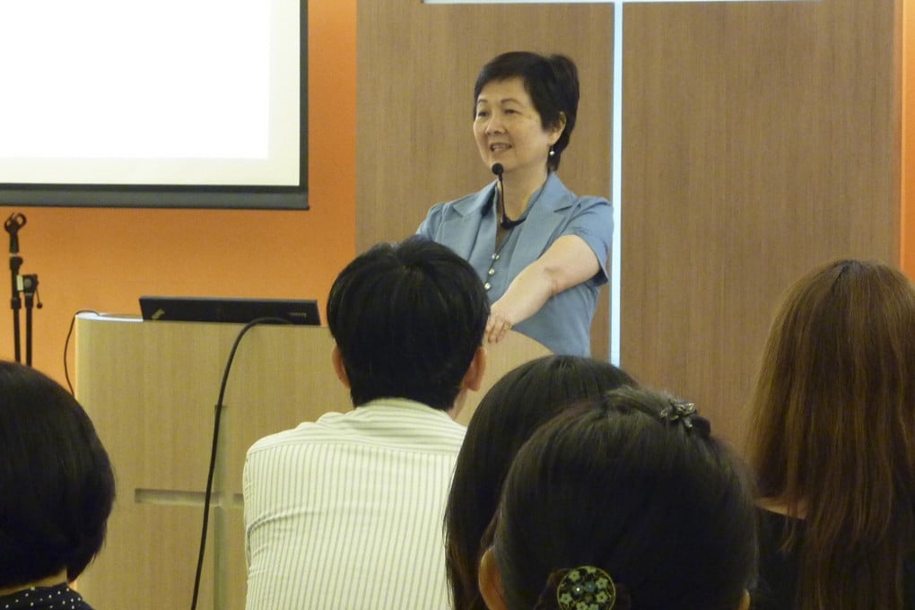 Yolanda Wong, who firmly believes in the direct involvement of parents in teaching special-needs children, leads a local seminar.