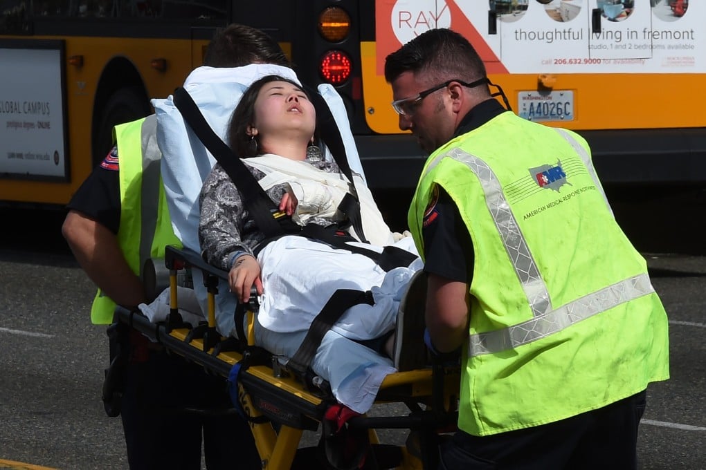 A victim of the collision between a tour "duck" and a bus carrying foreign university students is stretchered away from the scene of Thursday's crash in Seattle. Photo: AFP