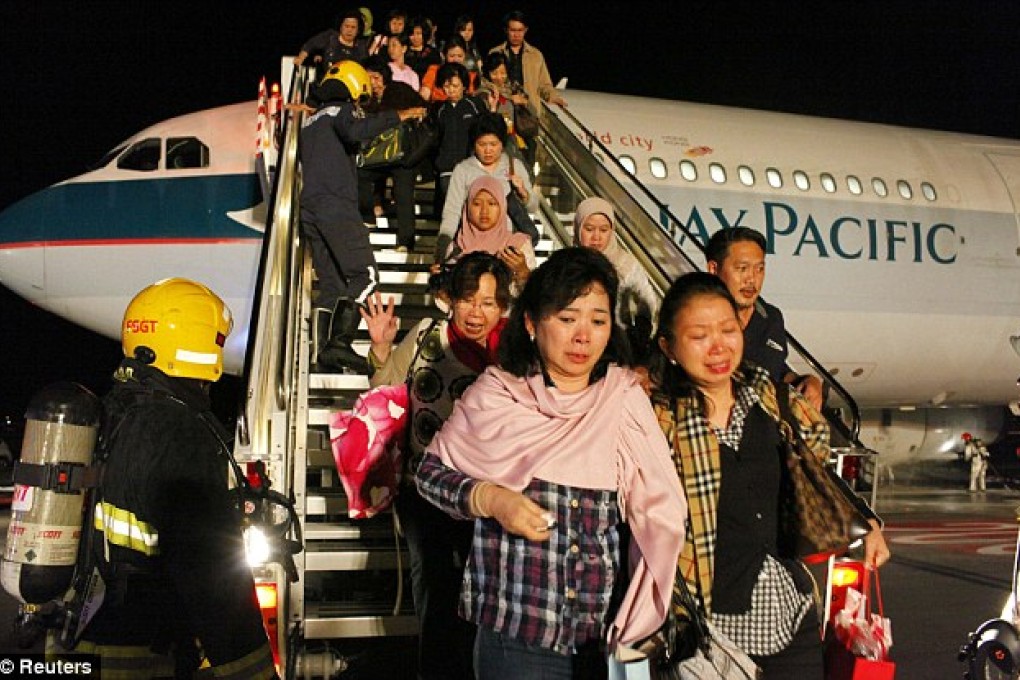Passengers disembarking in Singapore on May 16, 2011, after one of the plane's engines burst into flames mid-flight. Photo: Reuters