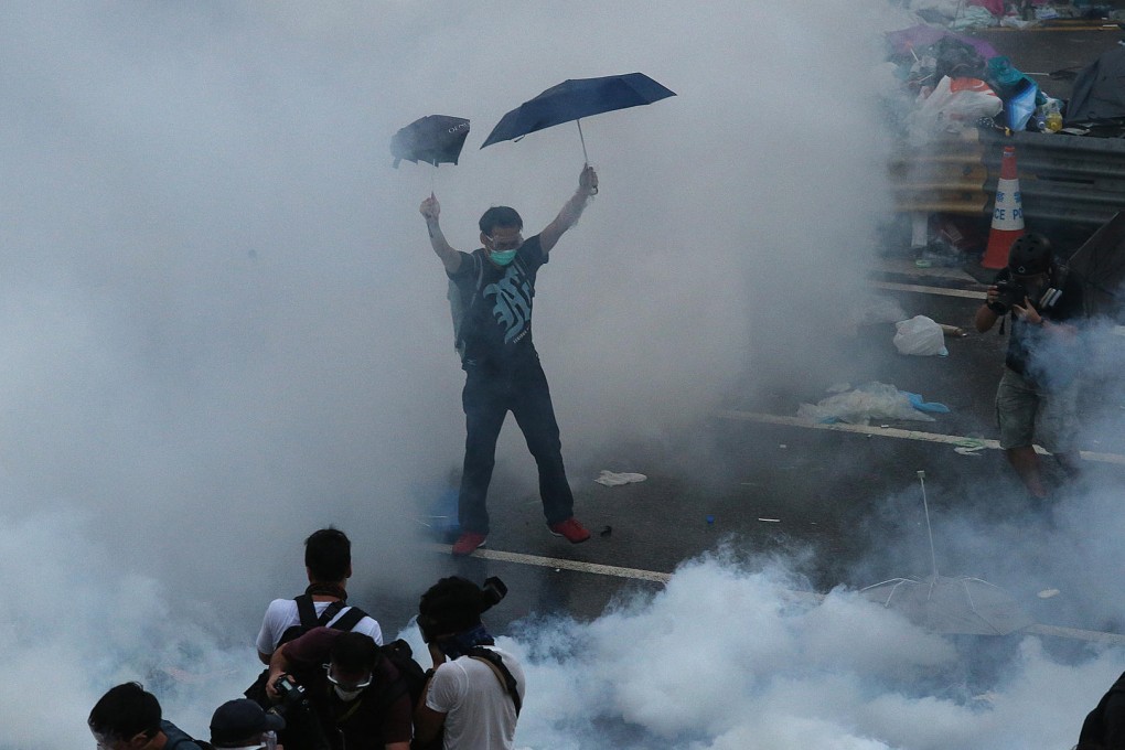 Police open fire with tear gas in Harcourt Road, Admiralty, after students storm the forecourt at government headquarters. Photo: K. Y. Cheng