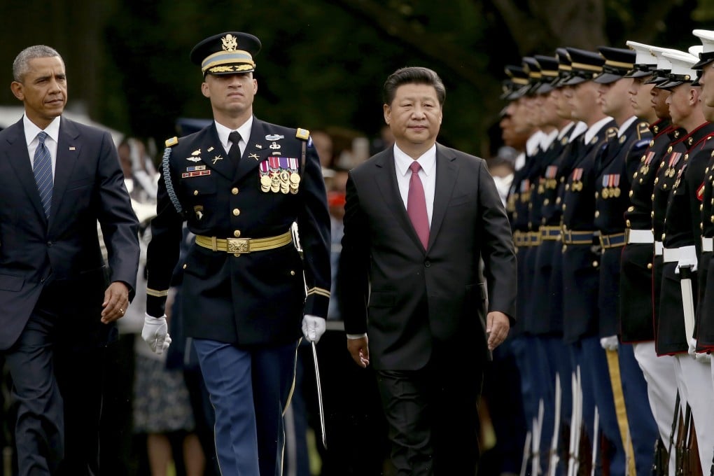 President Barack Obama and Chinese President Xi Jinping inspect the troops during an official state arrival ceremony for the Chinese president. Photo: AP