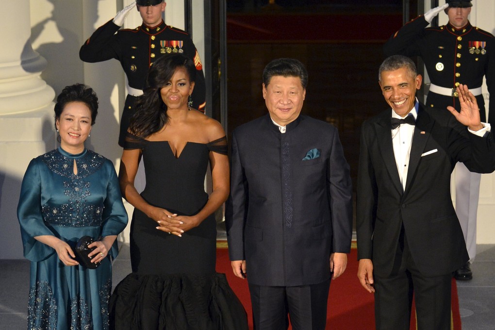US President Barack Obama and first lady Michelle Obama pose with Chinese President Xi Jinping and his wife Peng Liyuan as they arrive for a state dinner at the White House in Washington on Friday. Photo: Reuters