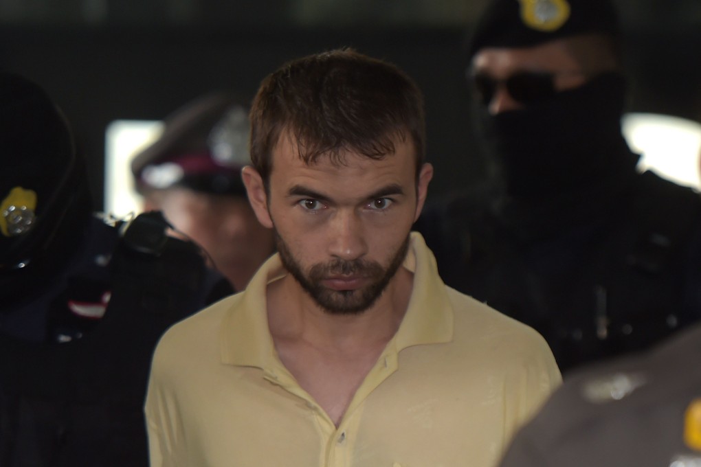 In this photo taken on September 5, a suspect identified by the ruling junta as Adem Karadag is escorted by Thai commando units upon his arrival at a court in Bangkok. Photo: AFP